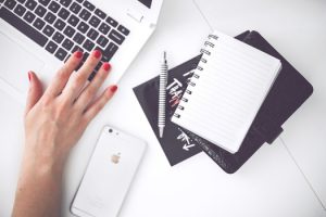 woman-hand-smartphone-desk-medium